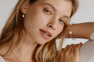 A woman wears her stunning Radiance mother of pearl jewellery collection, which features emerald cut pieces of Mother of Pearl shell grown at our Cygnet Bay Pearl Farm.