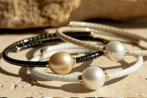 A collection of pearl jewellery pieces part of the Terra Range, featuring ceramic links and set in 18ct yellow gold.