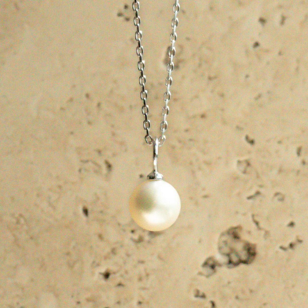 An Australian Akoya pearl set on a white gold charm pendant.