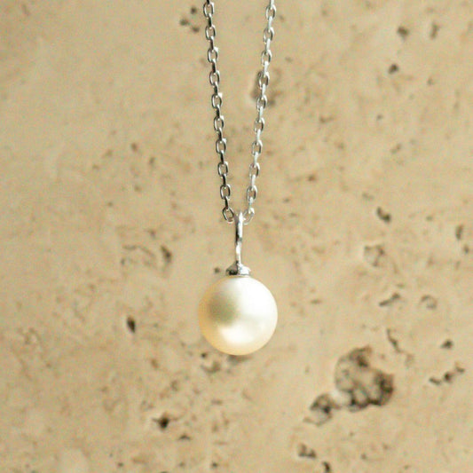 An Australian Akoya pearl set on a white gold charm pendant.