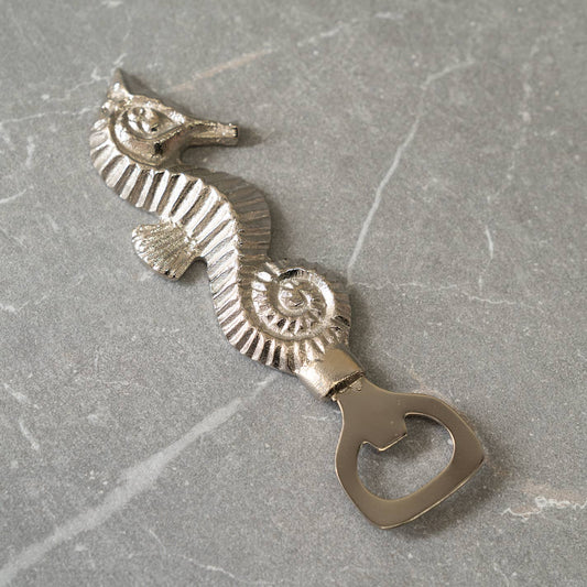 Made from durable stainless steel, this sleek silver bottle opener is not only functional but also adds a touch of coastal charm to your decor. The intricate etched seahorse design showcases attention to detail and craftsmanship.