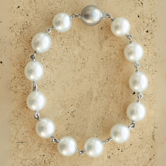 A Cocos Pearl Strand Bracelet featuring Australian South Sea pearls set in gold.