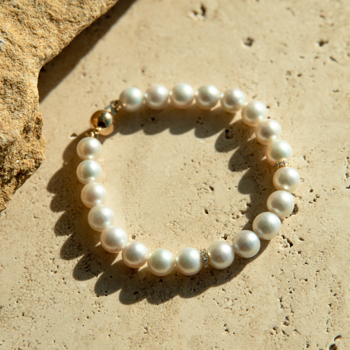 This Eternal Akoya & Diamond Strand Bracelet features twenty-one (21) Broken Bay (NSW) grown 7.5mm AAA grade Australian Akoya pearl set alongside two White Diamond rondels (0.22ct H/SI). This 18.5cm pearl strand is carefully hand strung with silk and set with an 18ct Yellow Gold Ball Clasp.