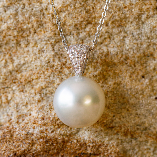 A beautiful Australian South Sea pearl pendant set with a stunning array of white diamonds in gold.