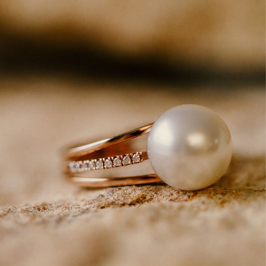 A striking pearl ring, featuring an Australian South Sea pearl set alongside a band of white glimmering diamonds.