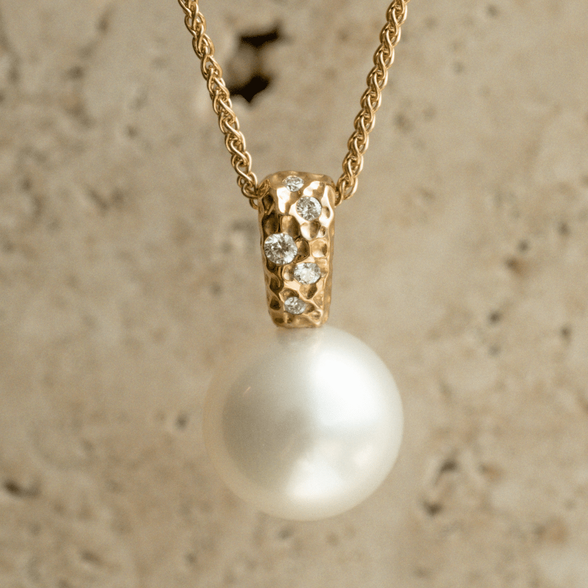 A stunning Australian South Sea pearl set on an Impressions pendant design featuring several white diamonds.