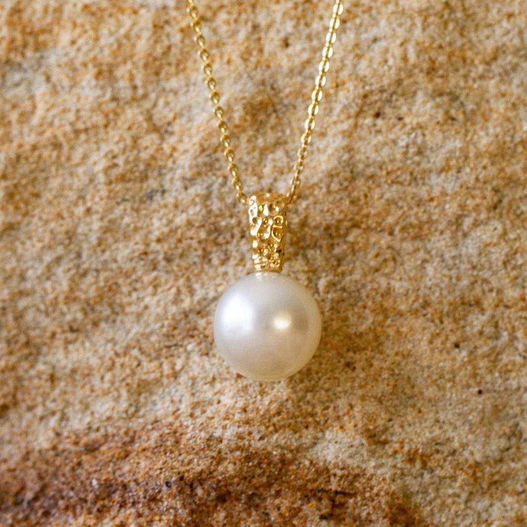 A stunning Australian South Sea pearl pendant set in a unique Impressions design with a hammered finish in gold.