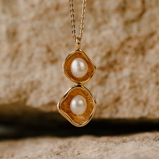 A stunning Kimberley Lily twin pendant featuring a pair of Cygnet Bay grown Australian South Sea keshi pearls set in a unique lily inspired design, in gold.