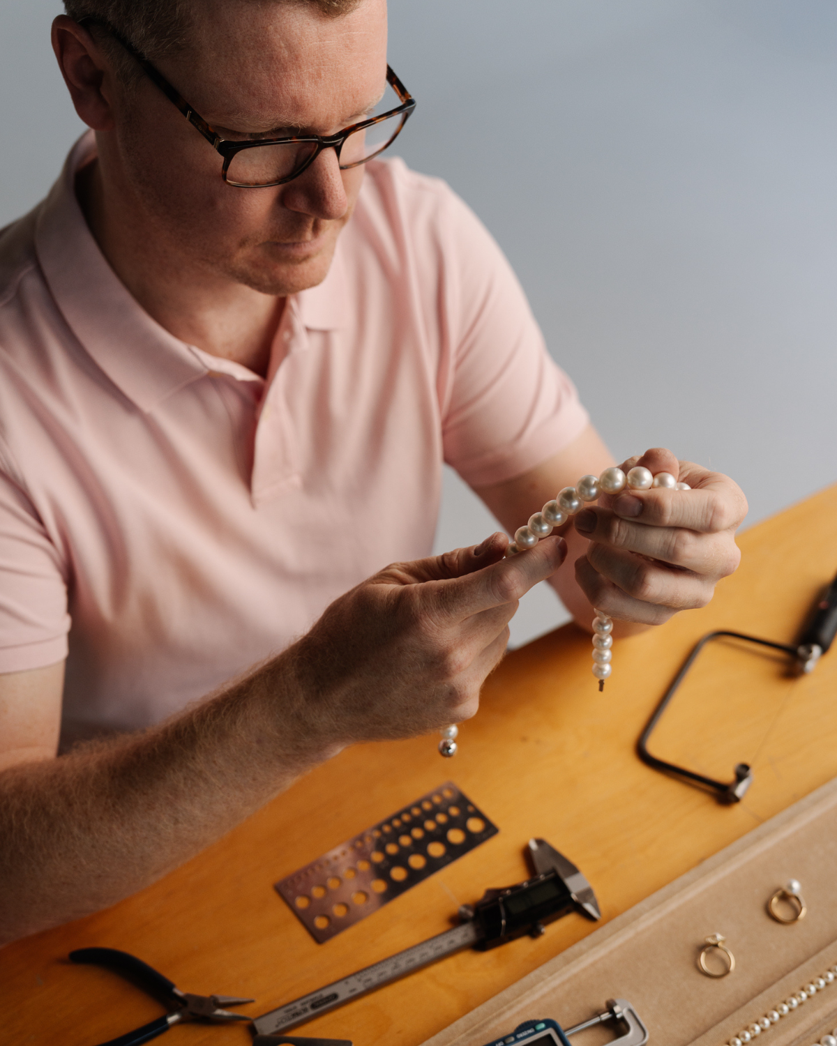 Our head jewellery Steven inspecting a stunning Australian South Sea pearl strand necklace, featuring Saltwater pearls grown at our Cygnet Bay pearl farm.