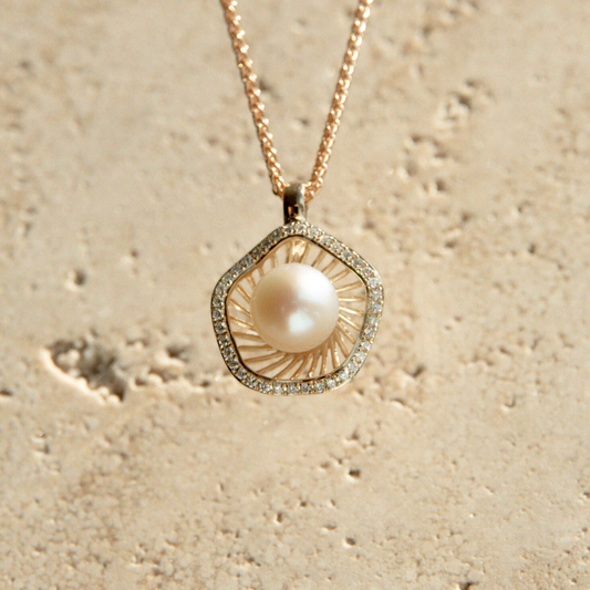 A stunning Mangrove Lily Pearl & Diamond Pendant featuring a Broken Bay (NSW) 7mm AAA grade Australian Akoya pearl complemented by a halo of thirty-eight (38) white diamonds set in 9ct gold.