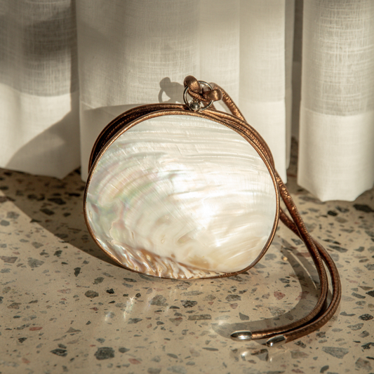 Exquisite Mother of Pearl Shell Clutch featuring premium leather detailing and an elegant sterling silver clasp.