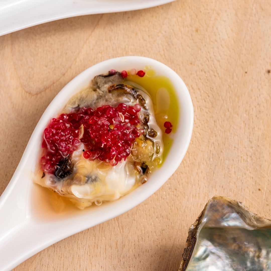 A delicious Australian Akoya oyster served in a white spoon.