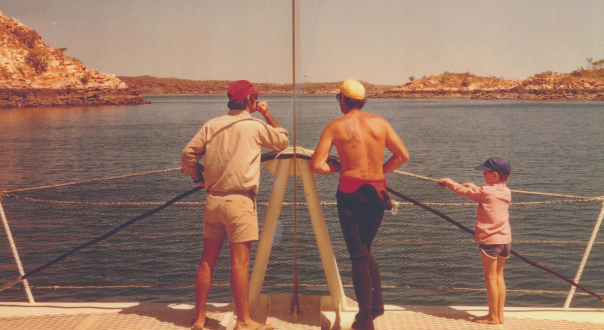 A historical photo of the Brown family standing at the end of a pearling vessel looking out at Cygnet Bay.