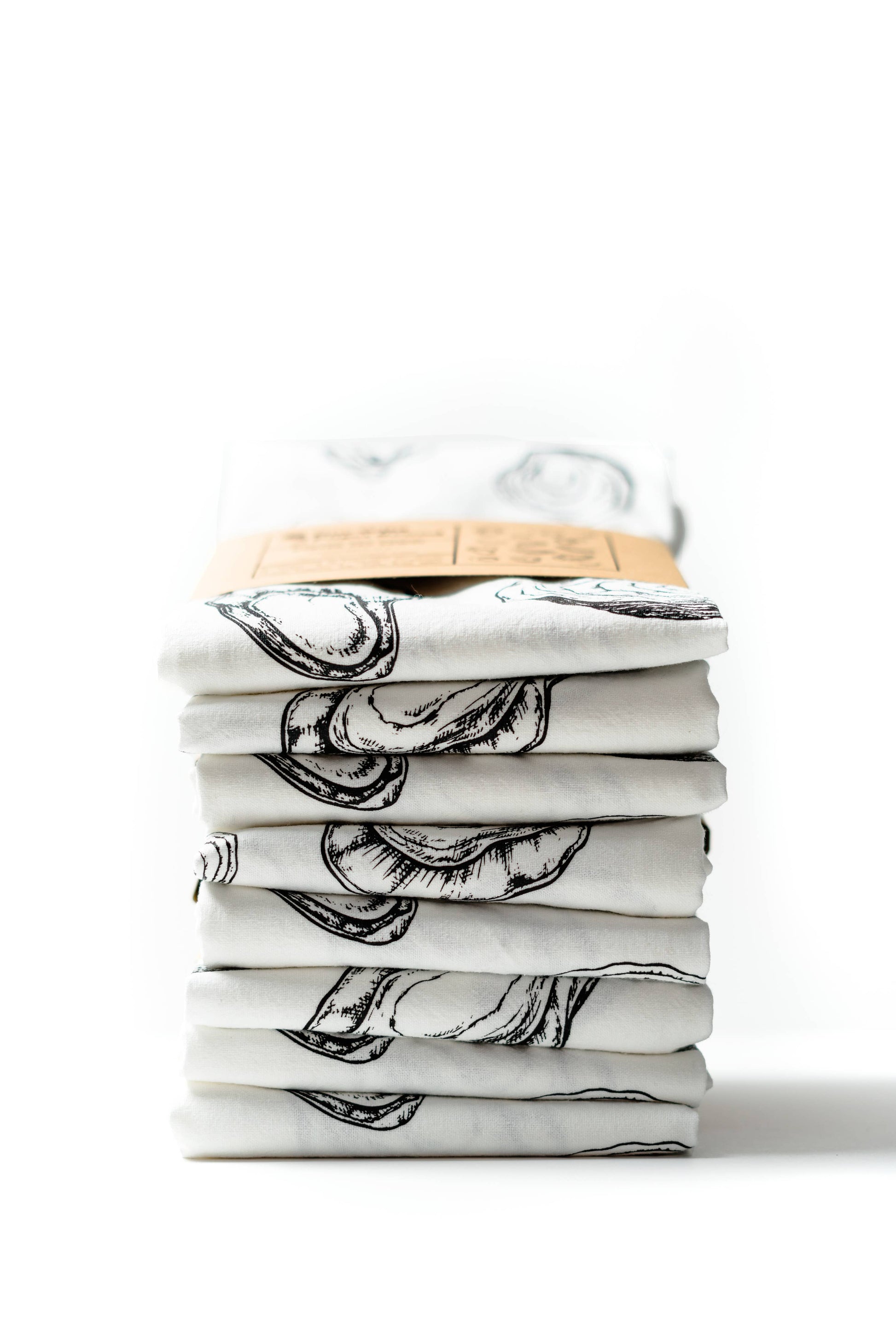Stack of folded white shirts with black graphics on a white background
