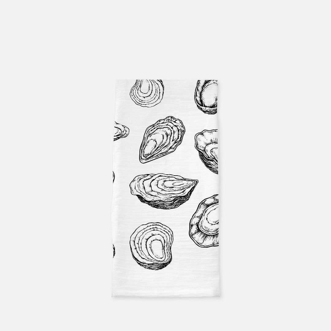 Tea towel with black and white oyster pattern on a white background