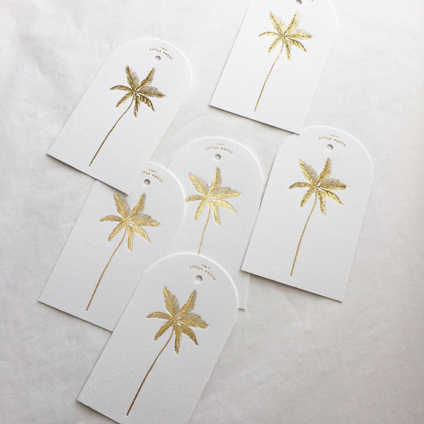 Luxury tags for gifting and decorating, in a die-cut arch shape with hole punch.