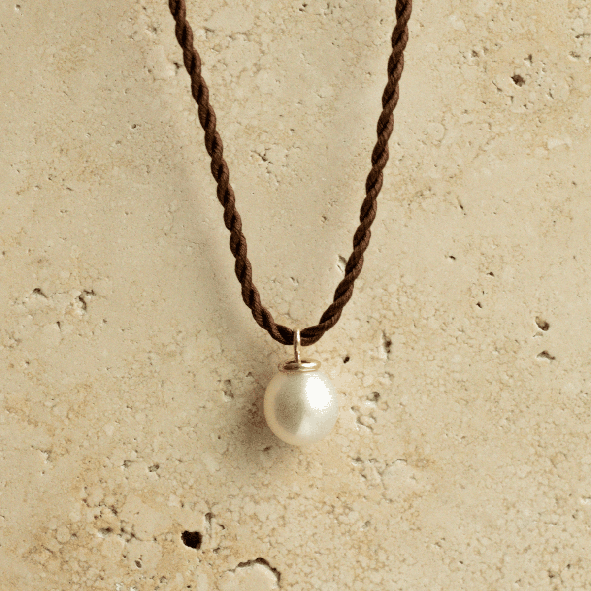 A classic Pearl Charm Silk Necklace featuring a Cygnet Bay (WA) grown Australian South Sea pearl set on a 100% silk cord rope.