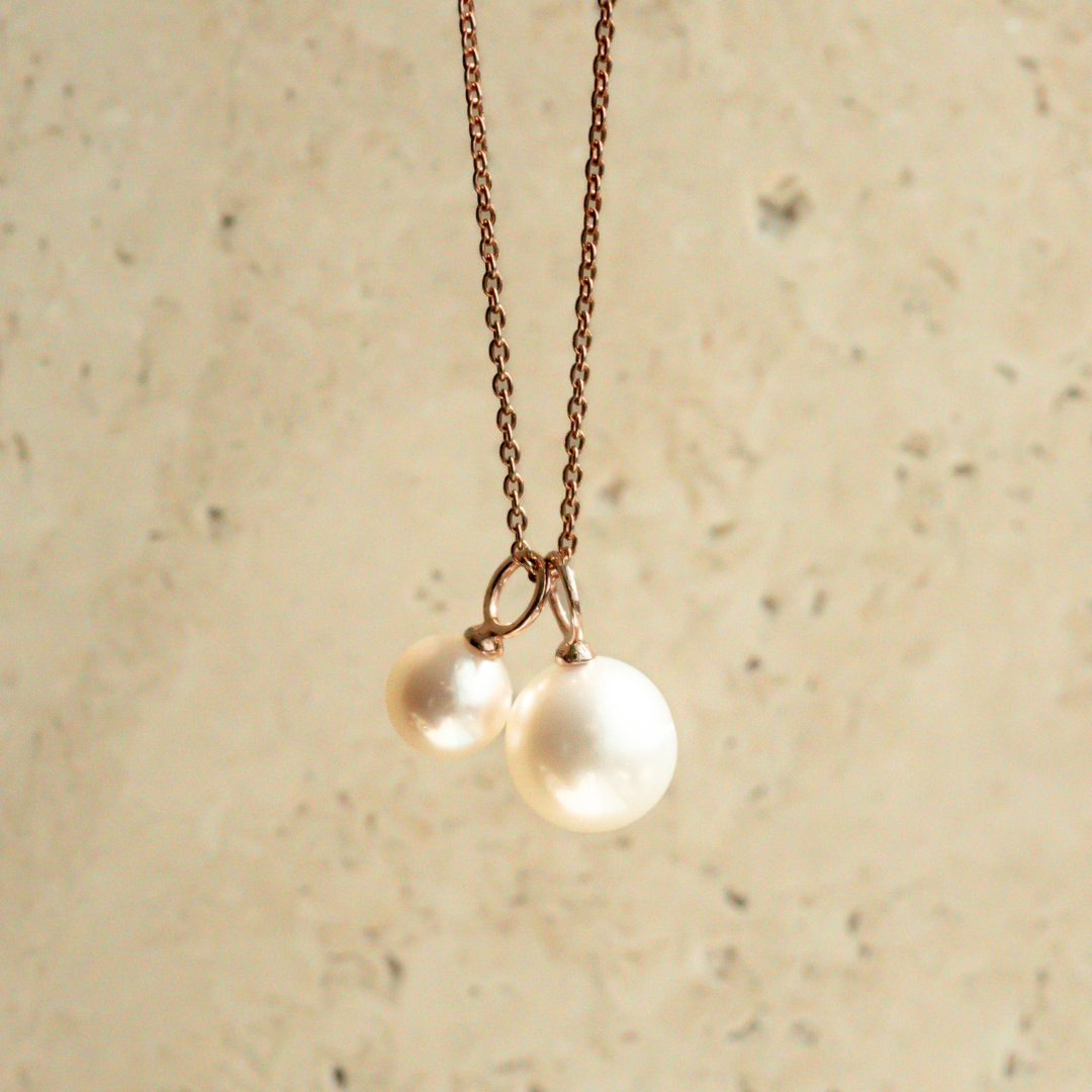 A beautiful Pearl Charm set featuring an Australian Akoya pearl and South Sea pearl set in rose gold, hung on a solid gold chain.
