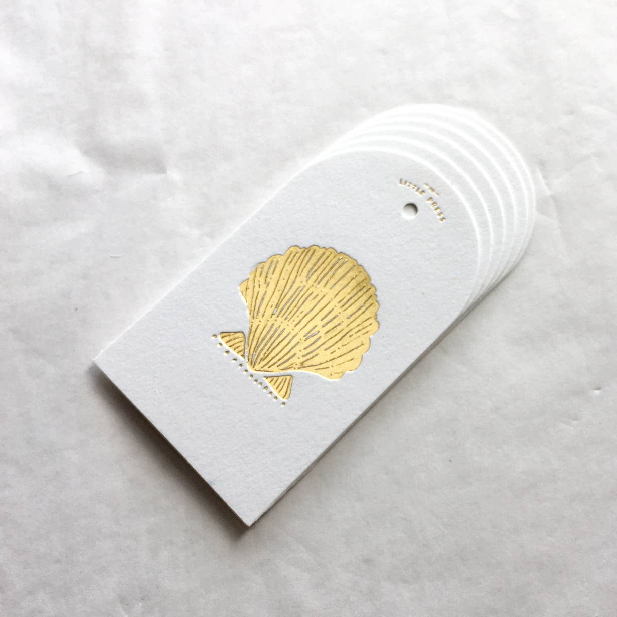 Luxury tags for gifting and decorating, in a die-cut arch shape with hole punch.