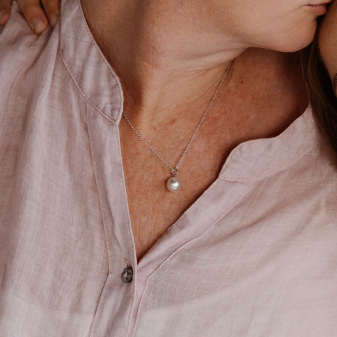 A woman wears her Australian South Sea Charm Pendant set in white gold.