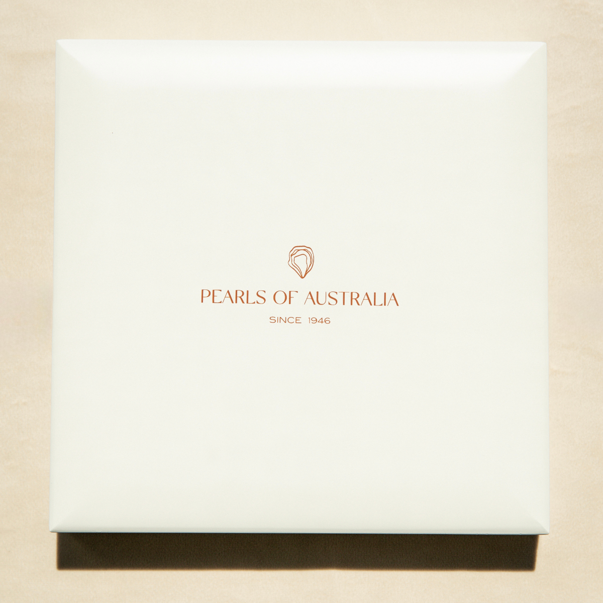 Pearls of Australia strand packaging box on a beige background
