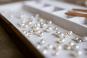 A tray of an array of Australian South Sea and Australian Akoya pearls of different colours, shapes, sizes. 