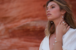 A woman wears her stunning Pearls of Australia pearl jewellery pieces, set in gold.