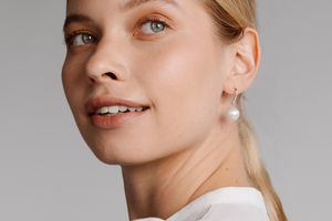 A woman wears her stunning Eternal Hooks that feature our Australian South Sea pearls set alongside stunning white diamonds in an elegant, timeless design.