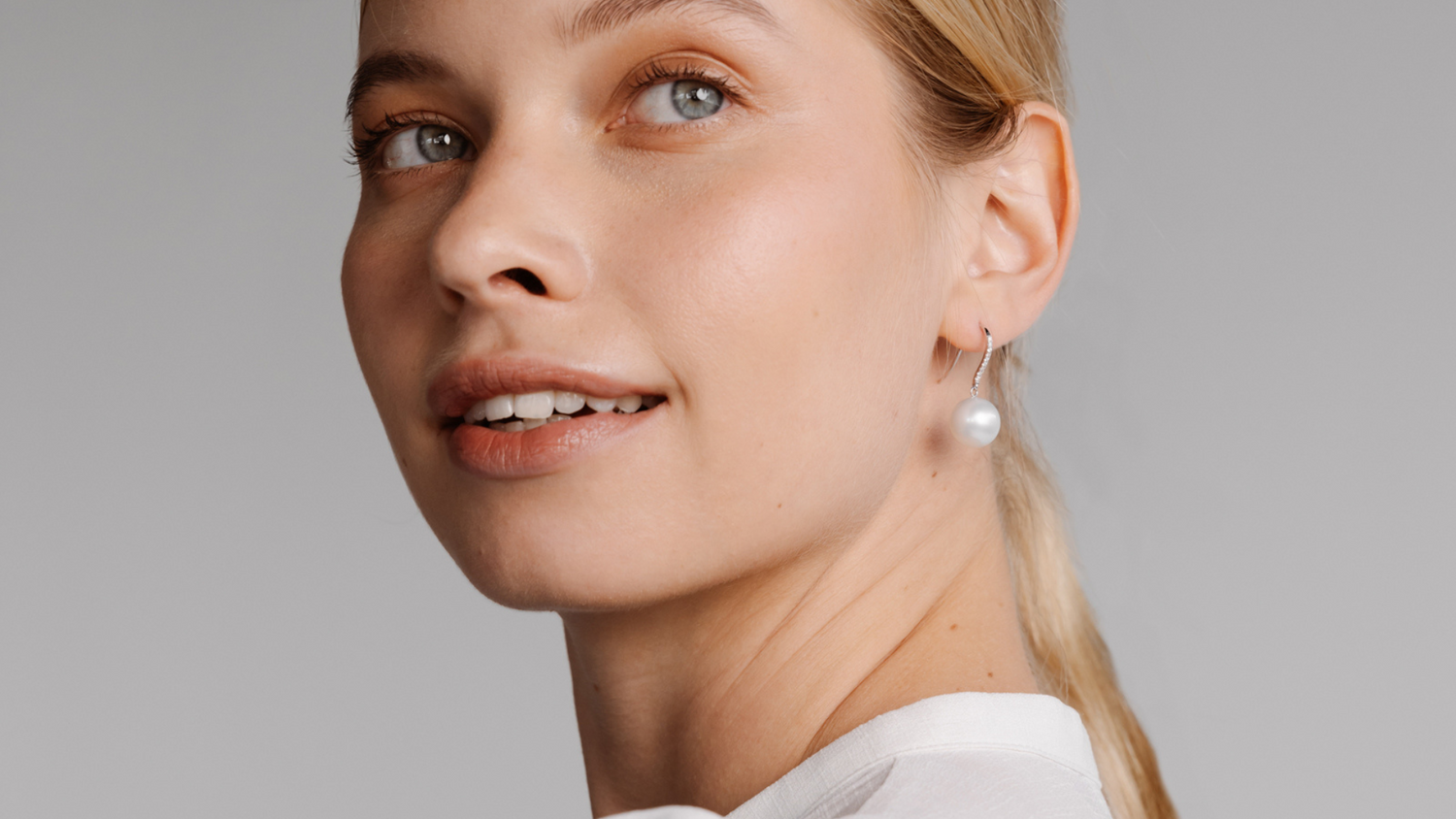 A woman wears her stunning Eternal Hooks that feature our Australian South Sea pearls set alongside stunning white diamonds in an elegant, timeless design.