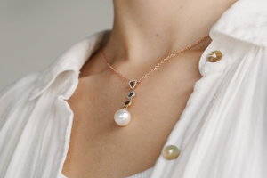 A woman wears her stunning limited edition pearl jewellery piece, which features our Australian grown saltwater pearls set alongside three types of metal and diamonds.