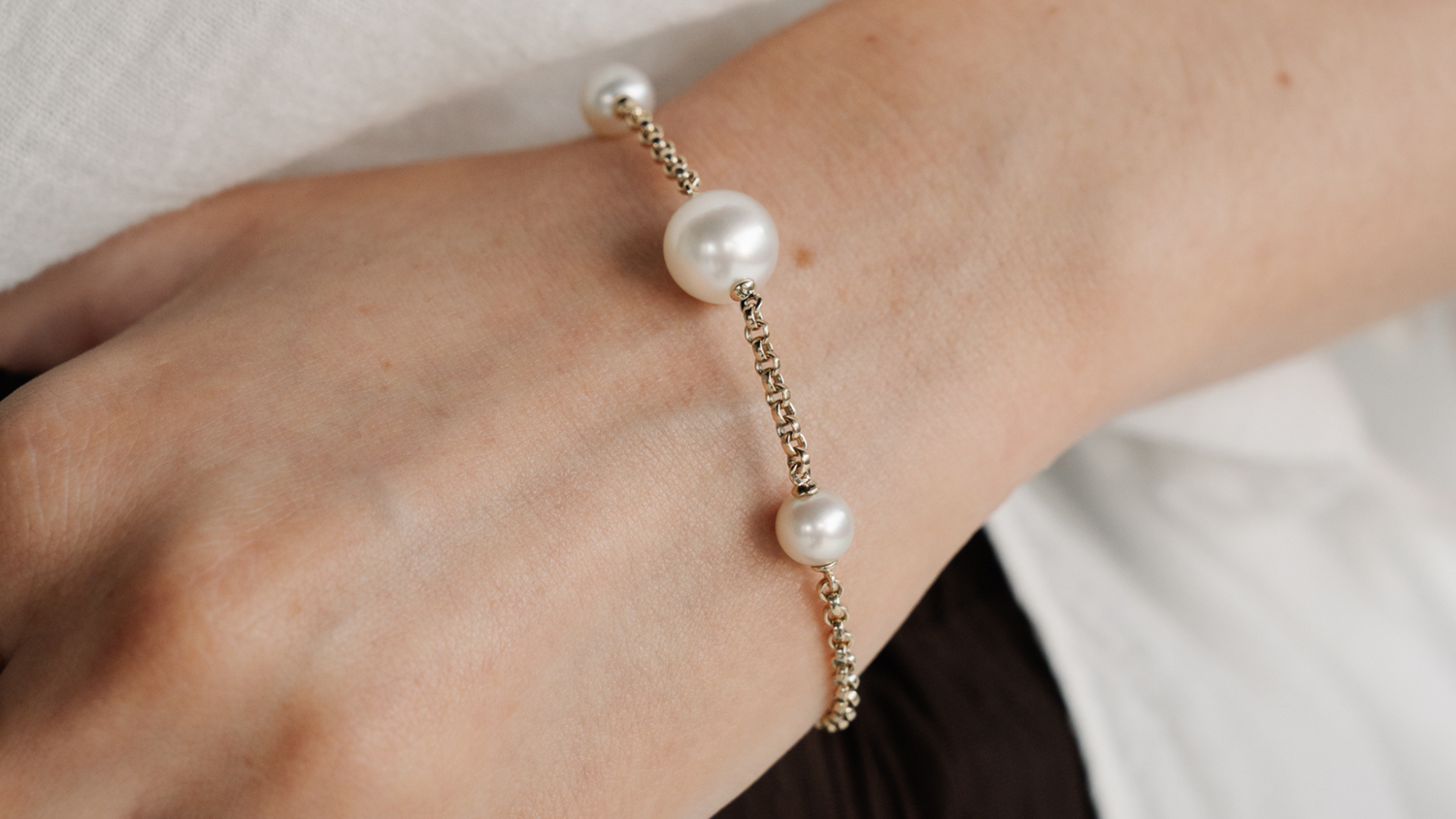 A woman wears her stunning Provenance Pearl Bracelet that feature Australia Akoya and South Sea pearls from both Broken Bay and Cygnet Bay Pearl Farm.