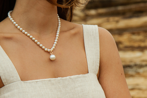 A woman wears her stunning Australian Akoya pearl strand necklace adorned with a Pearl Pendant.