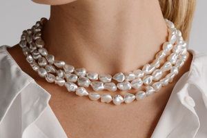 A woman wears her stunning Australian Keshi Pearl strand necklace, that feature over 100 keshi pearls from our Cygnet Bay Pearl Farm.