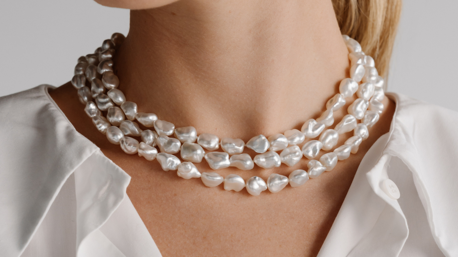 A woman wears her stunning Australian Keshi Pearl strand necklace, that feature over 100 keshi pearls from our Cygnet Bay Pearl Farm.