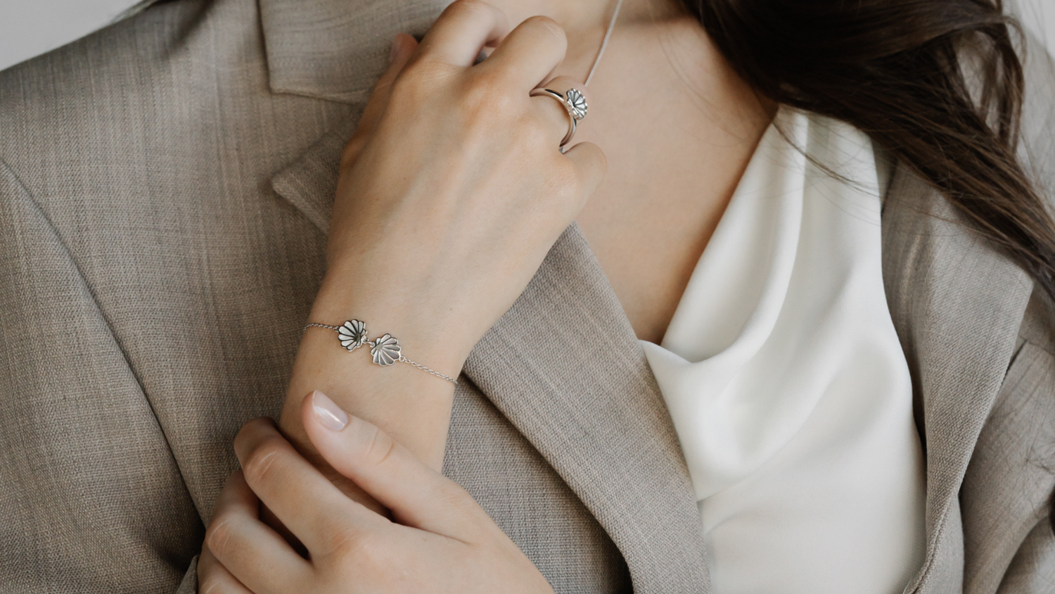 A woman wears her sterling silver jewellery pieces that feature our Cygnet Bay grown Mother of Pearl shell.