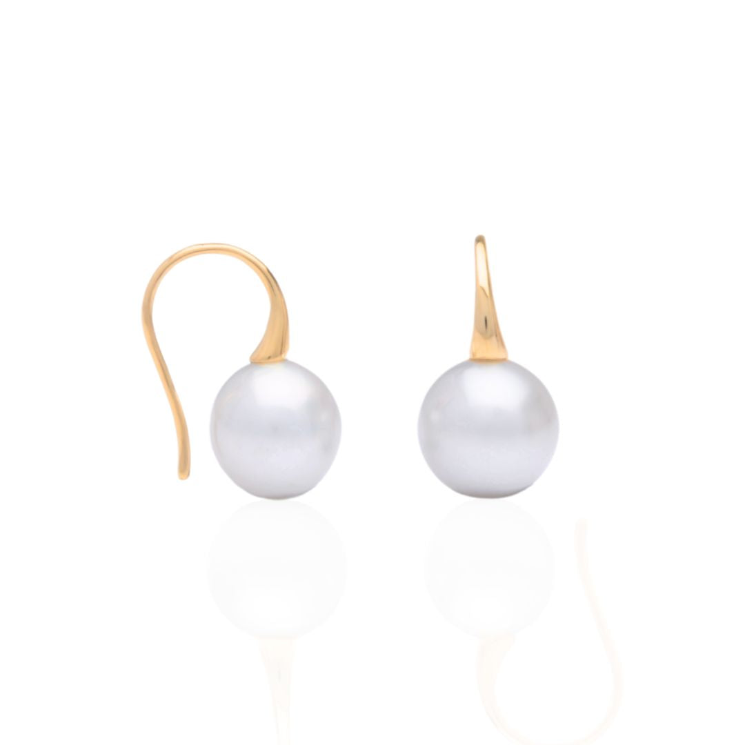 A pair of Australian South Sea pearl hook earrings set in yellow gold.