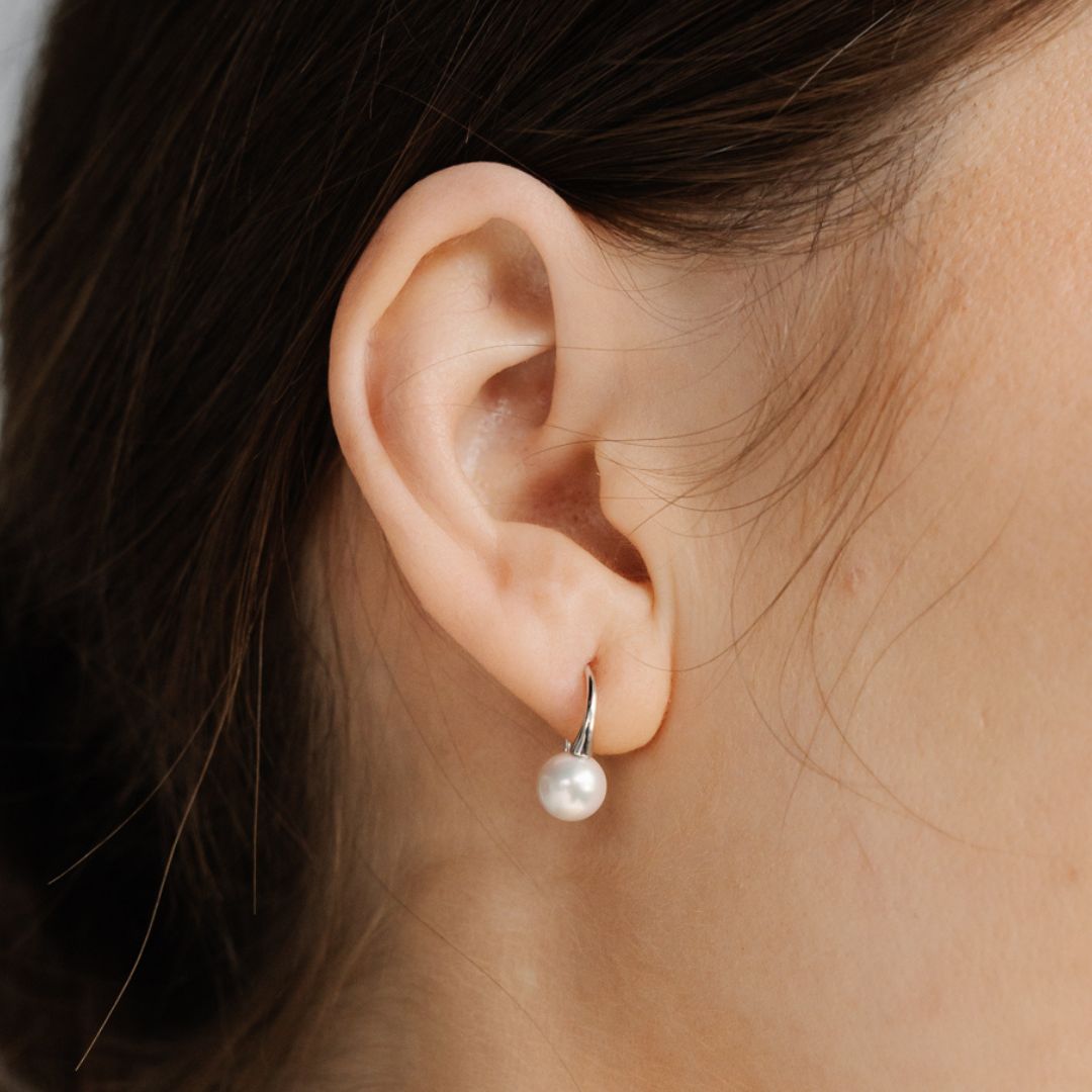 A woman wears her stunning Australian Akoya pearl hook earrings.