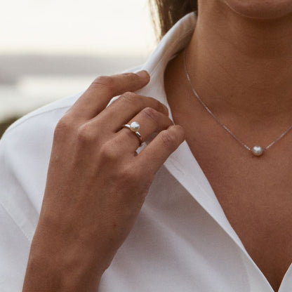 A person wears their stunning Acacia Petite Ring featuring a Broken Bay grown Australian Akoya pearl set in solid gold.