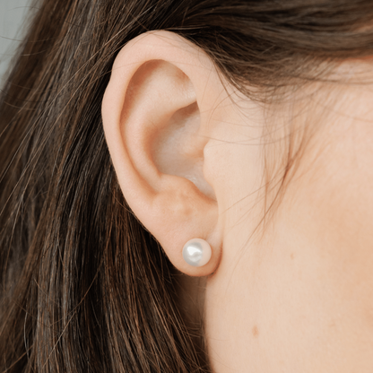 A woman wears her beautiful Australian Akoya pearl studs. 