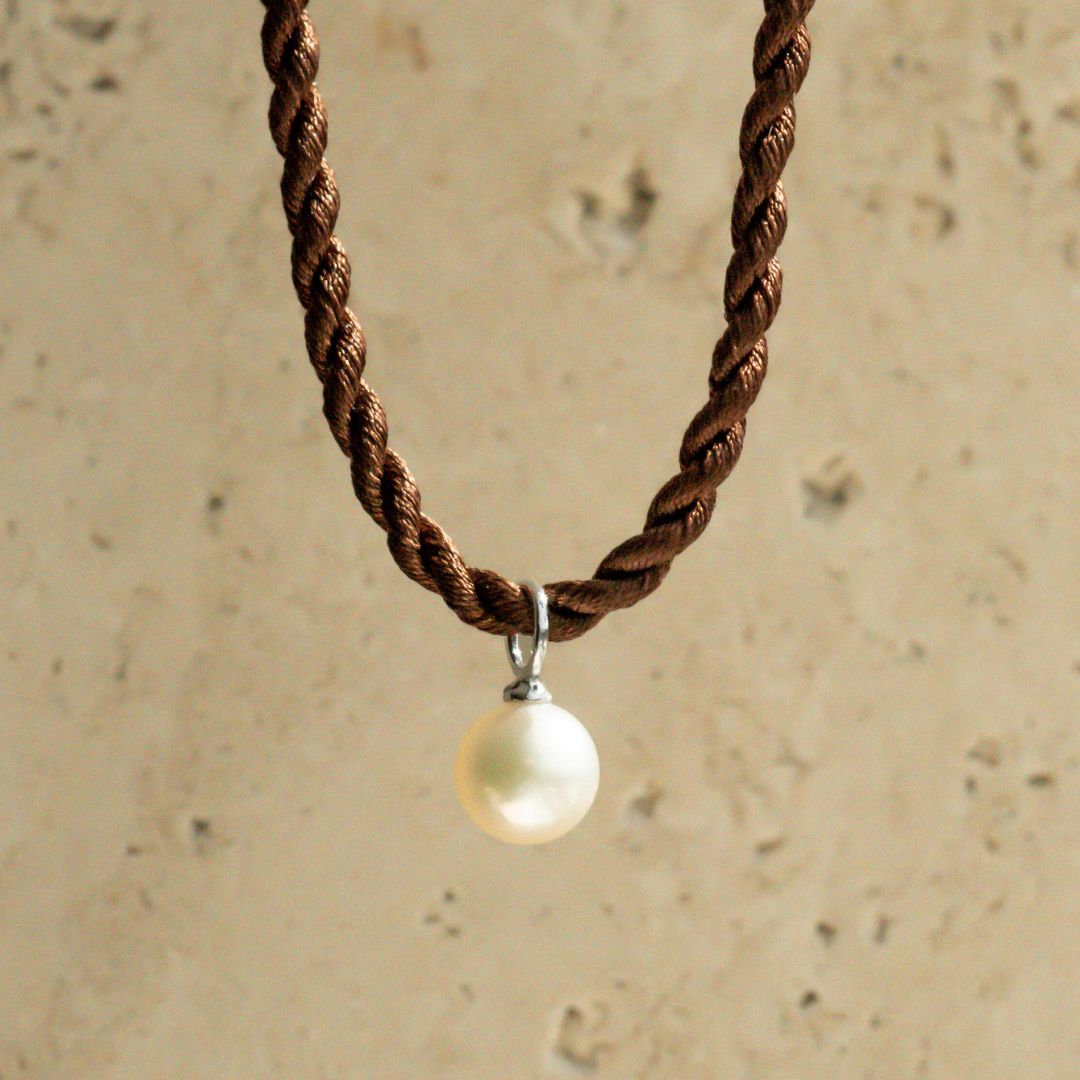 An Australian Akoya pearl set on a white gold charm pendant. 