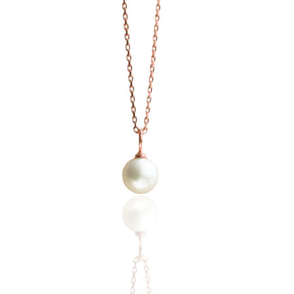 An Australian Akoya pearl set on a rose gold charm pendant. 