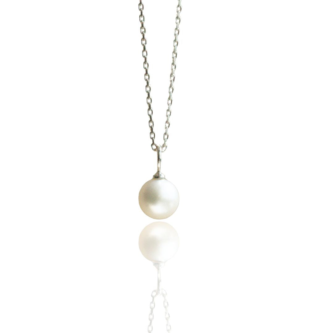 An Australian Akoya pearl set on a white gold charm pendant. 