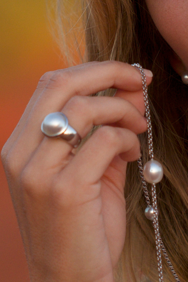 A photo of a person wearing their beautiful Mabe pearl ring set in sterling silver. 