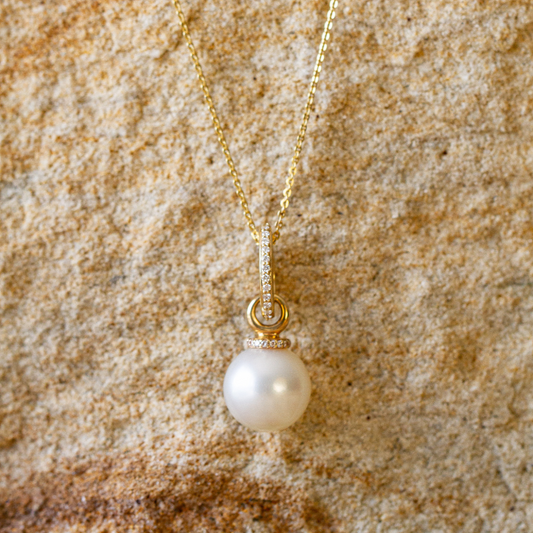 A beautiful Australian South Sea pearl set alongside an array of white sparkling diamonds on a pendant.