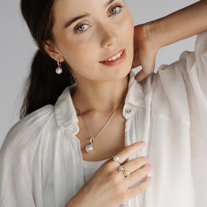 A woman wears her stunning Banksia Pearl Pendant that features a Cygnet Bay grown Australian South Sea pearl set alongside diamonds. 