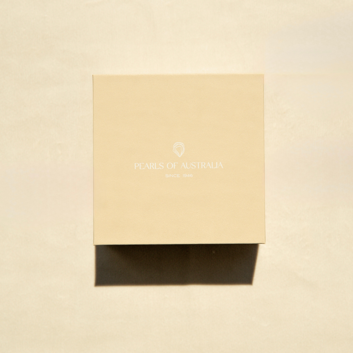 Beige box with 'Pearls of Australia' branding on a beige background