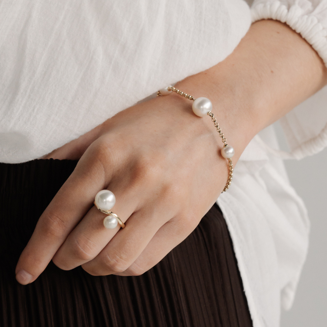 A woman wears her beautiful Australian South Sea and Akoya pearl chain bracelet.