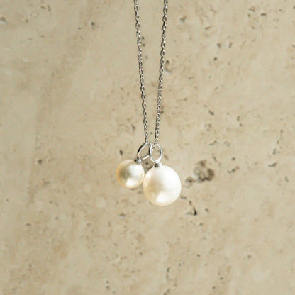 A charming set featuring an Australian South Sea pearl and Australian Akoya pearl hung on a chain.