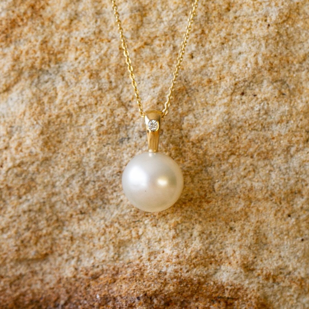 A beautiful Australian South Sea pearl pendant set in gold with a single white diamond.