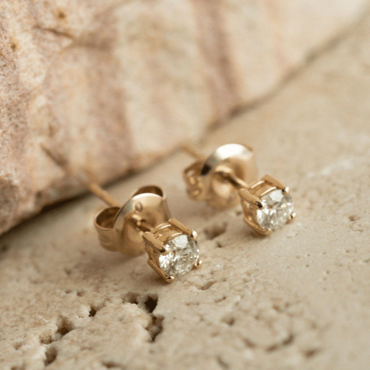 A pair of classic, brilliant cut Diamond Stud Earring set in gold.